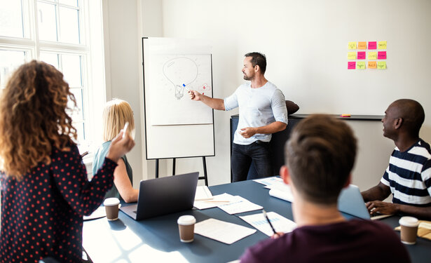 Manager giving a presentation on creativity to office colleagues